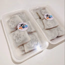 Packaged Korean rice cakes with visible brand stickers on a white background