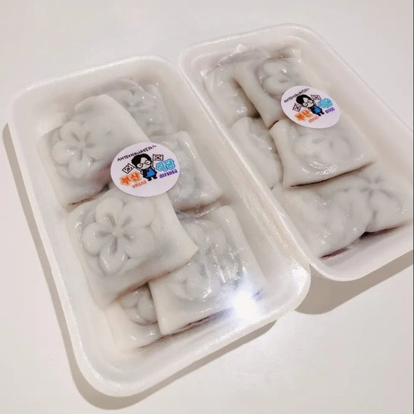 Packaged Korean rice cakes with visible brand stickers on a white background