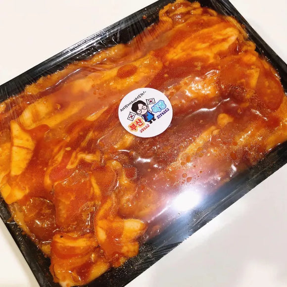 Beef Belly in Yangnyeom in a black plastic container with a brand label on a white background
