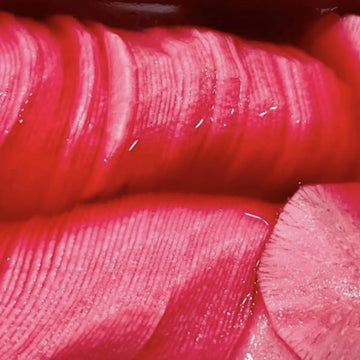 A close-up image of pickled radishes, showing the texture and color of the dish.