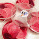 Plastic containers with sliced radishes and a visible brand sticker on a white background