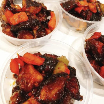 Plastic containers with deep-fried crispy mushrooms and vegetables on a white surface