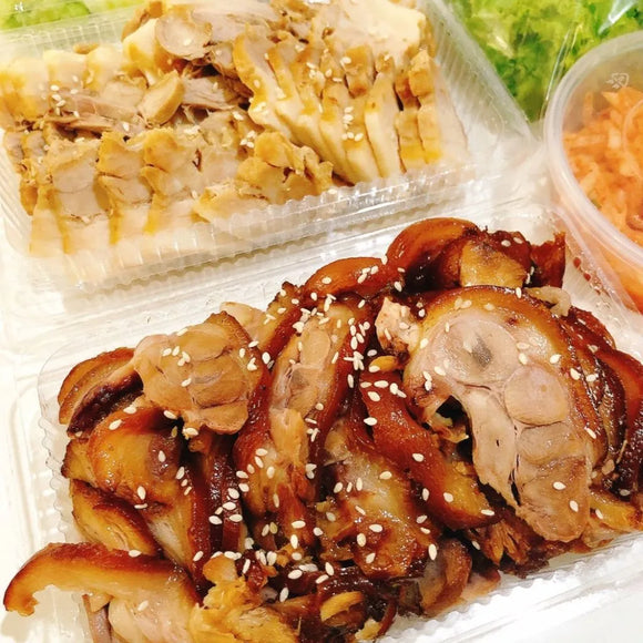 Prepared dishes on plates, likely to be part of a meal set, with visible pieces of meat and vegetables.