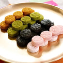 Assorted colorful Korean cookies on a gold plate