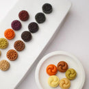 Colorful Korean cookies on a white plate with a white background