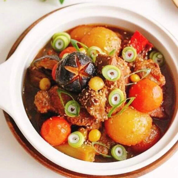 Stew with vegetables in a white bowl on a light background