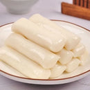 A plate of freshly made garaetteok, a type of Korean rice cake.