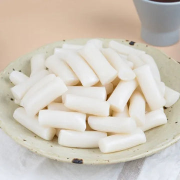 A plate of freshly made garaetteok, a type of Korean rice cake.