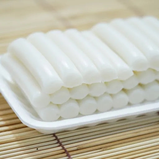A plate of freshly made garaetteok, a type of Korean rice cake.