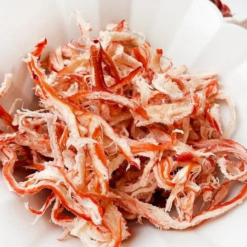 Dried squid strips on a white plate