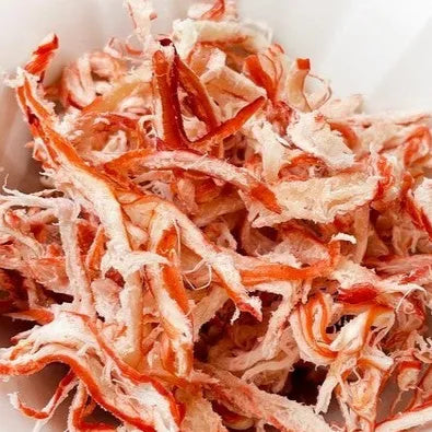 Dried squid strips on a white plate