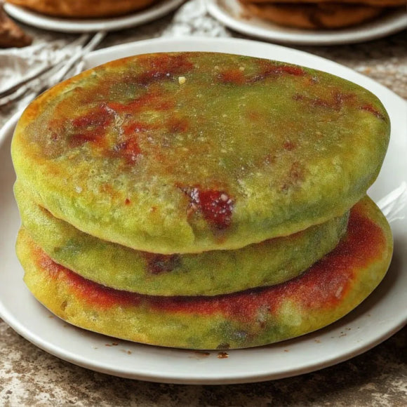 Stack of green tea and honey hotteok on a white plate
