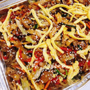 A platter of Japchae, which is sweet potato noodles stir-fried with vegetables and ground pork, garnished with sesame seeds and crispy strips.