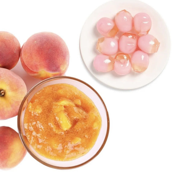 Peaches, peach puree, and peach Korean jellies on a white background