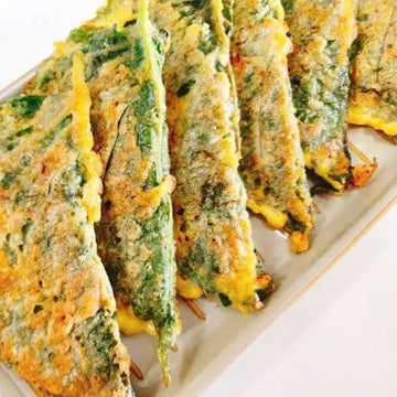 Kkaennip jeon slices on a white plate
