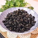 A bowl of braised black soybeans, typically served as a side dish in Korean cuisine.