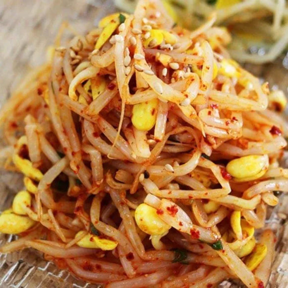 A plate of Korean soybean sprout side dish, Kongnamul-Muchim, with visible sesame seeds and seasonings.