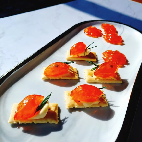Small appetizers with rKumquat Jelly on a white plate