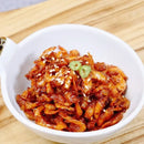 White bowl filled with Korean dried shrimp side dish on a wooden surface