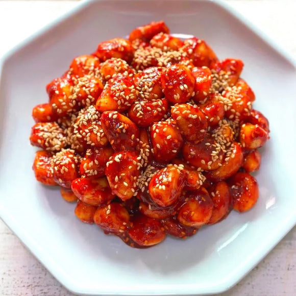 Plated garlic banchan of sesame-covered food on a white plate