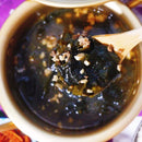 Spoonful of Korean seaweed and beef over a bowl.