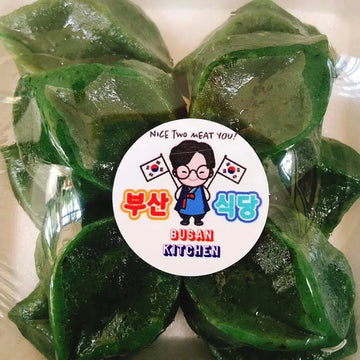 Green leafy Tteok package with a 'Busan Kitchen' label on a white background