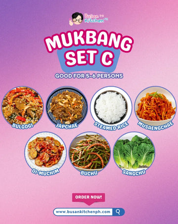 Promotional image of a Mukbang set with various Korean dishes on a pink and purple gradient background.