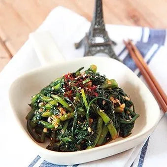 Bowl of seasoned watercress marinated with a flavorful blend of garlic, soy, sesame oil
