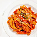 Korean stir-fried fish cakes with sesame seeds on a white plate