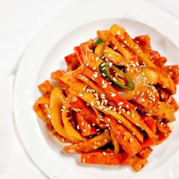 Korean stir-fried fish cakes with sesame seeds on a white plate