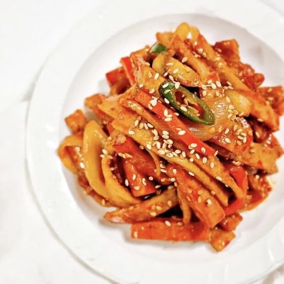 Korean stir-fried fish cakes with sesame seeds on a white plate
