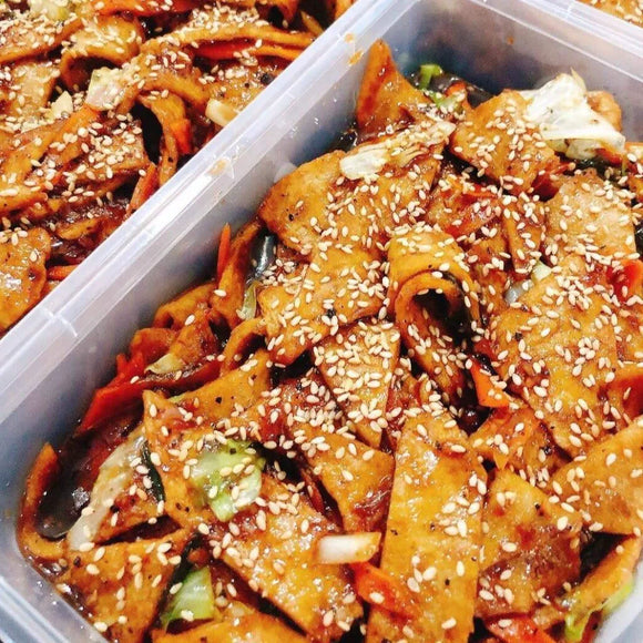 Korean stir-fried fish cakes with sesame seeds in a plastic container