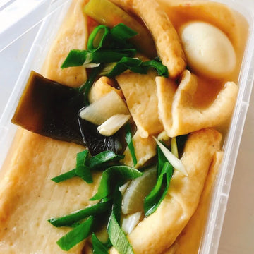 Odengtang. Container of tofu with vegetables on a white background