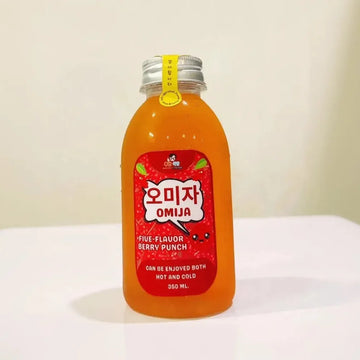 Bottle of OMIJA Five Flavor Berry Punch on a white surface with a light background