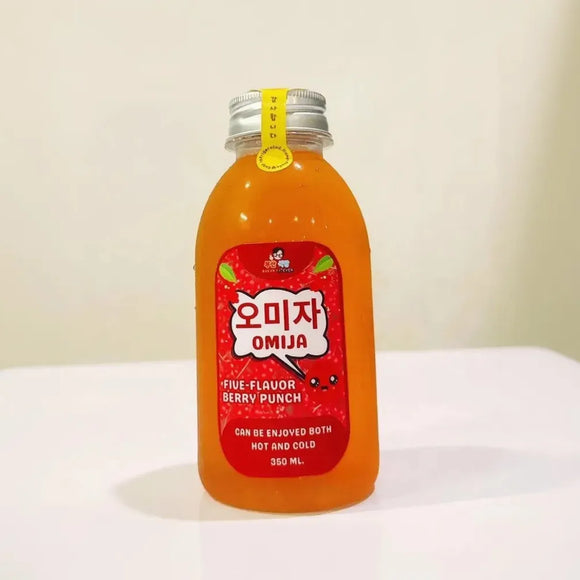 Bottle of OMIJA Five Flavor Berry Punch on a white surface with a light background