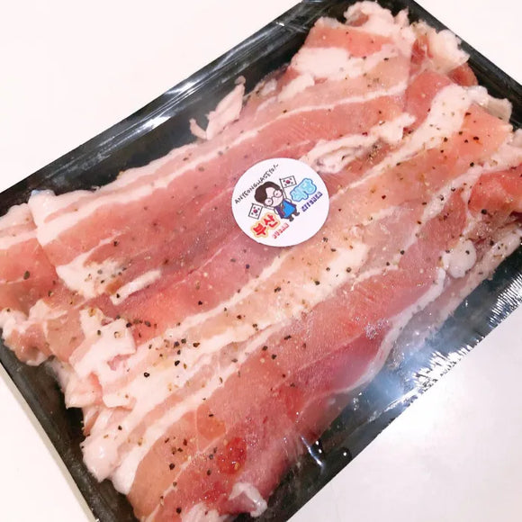 Packaged Pork Belly in herbs and salt, USDA raw meat with a visible brand label on a white background