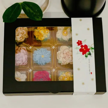 Decorative box with dasik tteok on a white surface