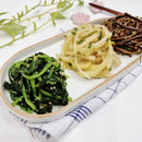 Two plates of food on a white surface with a decorative background