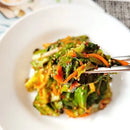 Korean lettuce salad with green leaves and carrots on a white plate