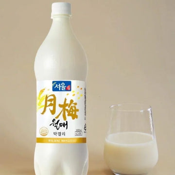 Bottle of Sooam brand milk with a glass on a beige background
