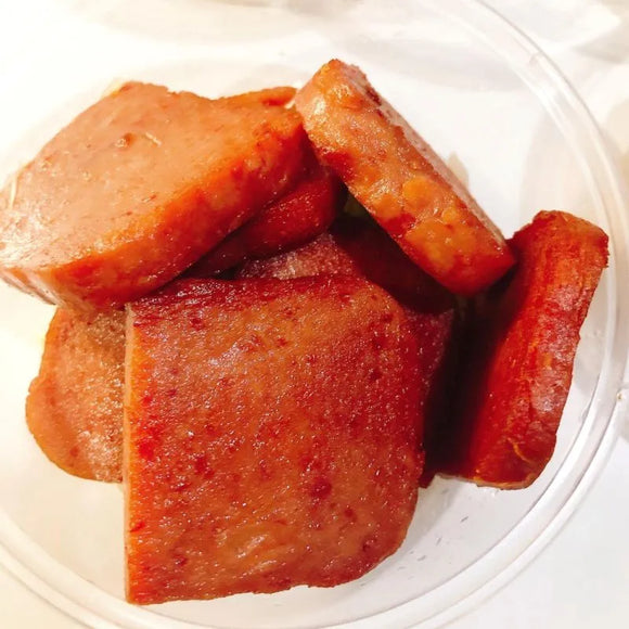 Close-up of sliced Korean spam on a white plate