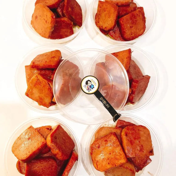 Plastic containers with Korean spam on a white background