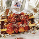  Korean street food featuring sausages and rice cakes on a skewer and on a piece of tinfoil.