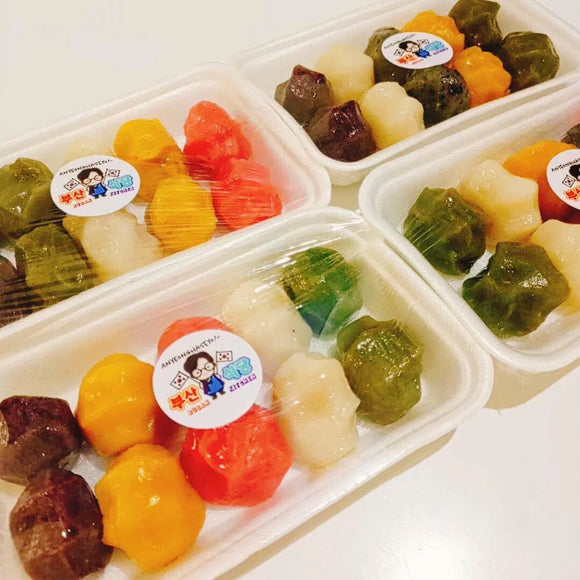 Colorful Special Songpyeon in plastic containers with a visible brand label on a white background.