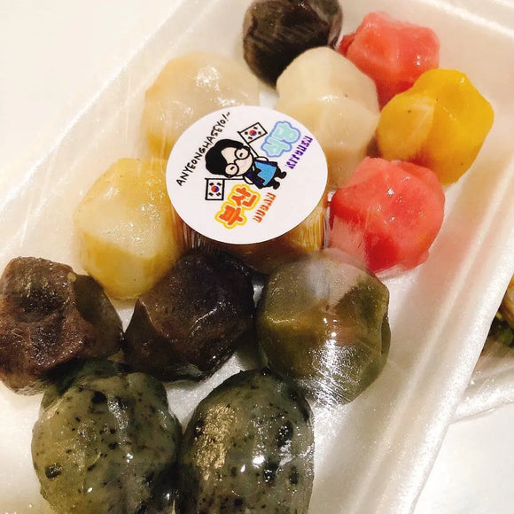 Assorted colorful Special Songpyeon with a brand label on a white background