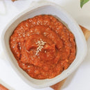 Ssamjang, an authentic Korean condiment in a white bowl with a white background