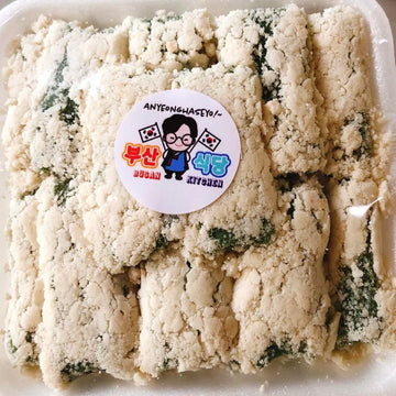 Packaged rice cake (tteok) covered with roasted soybean powder with a visible brand label on a white background