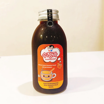 Bottle of Sujungga drink with an orange label on a white surface