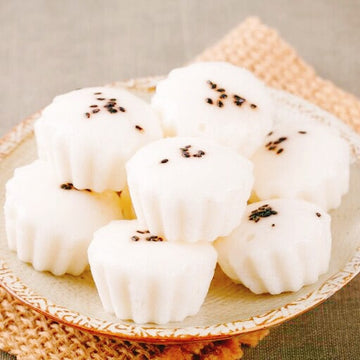 Alcohol rice cake with black sesame seeds on a woven mat