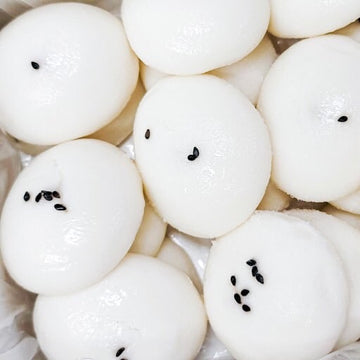Alcohol rice cake with black sesame seeds on a white background